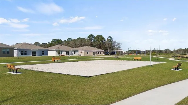 a view of a swimming pool with a yard and lake view