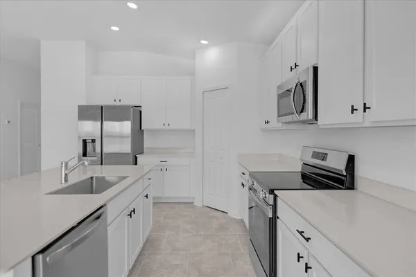 a kitchen with stainless steel appliances granite countertop a sink stove and cabinets