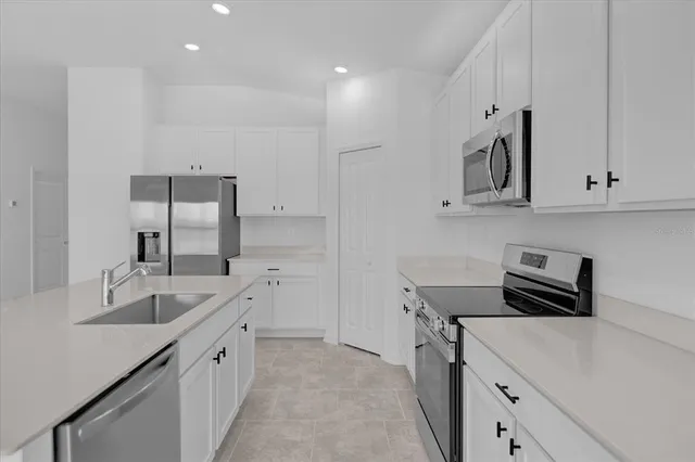 a kitchen with stainless steel appliances granite countertop a sink stove and cabinets