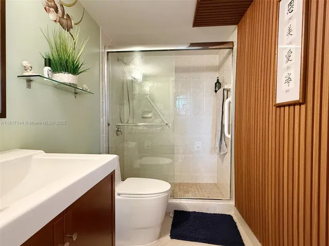 a kitchen with stainless steel appliances granite countertop a refrigerator a stove and a sink