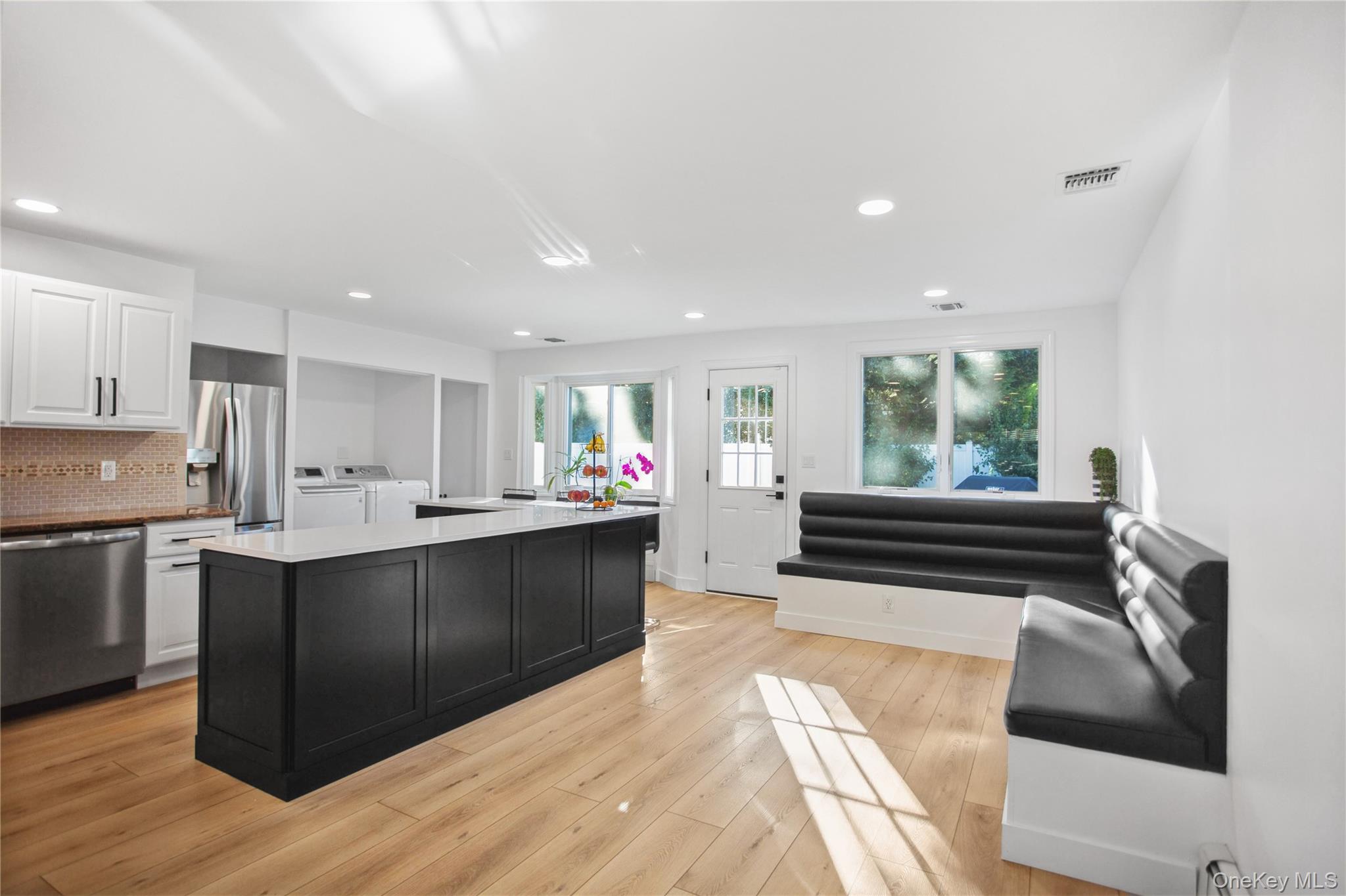 110 Hampton Way Merrick, NY 11566 - Photo 11 of 24 Kitchen with dark cabinets, white cabinetry, stainless steel appliances, recessed lighting, and backsplash