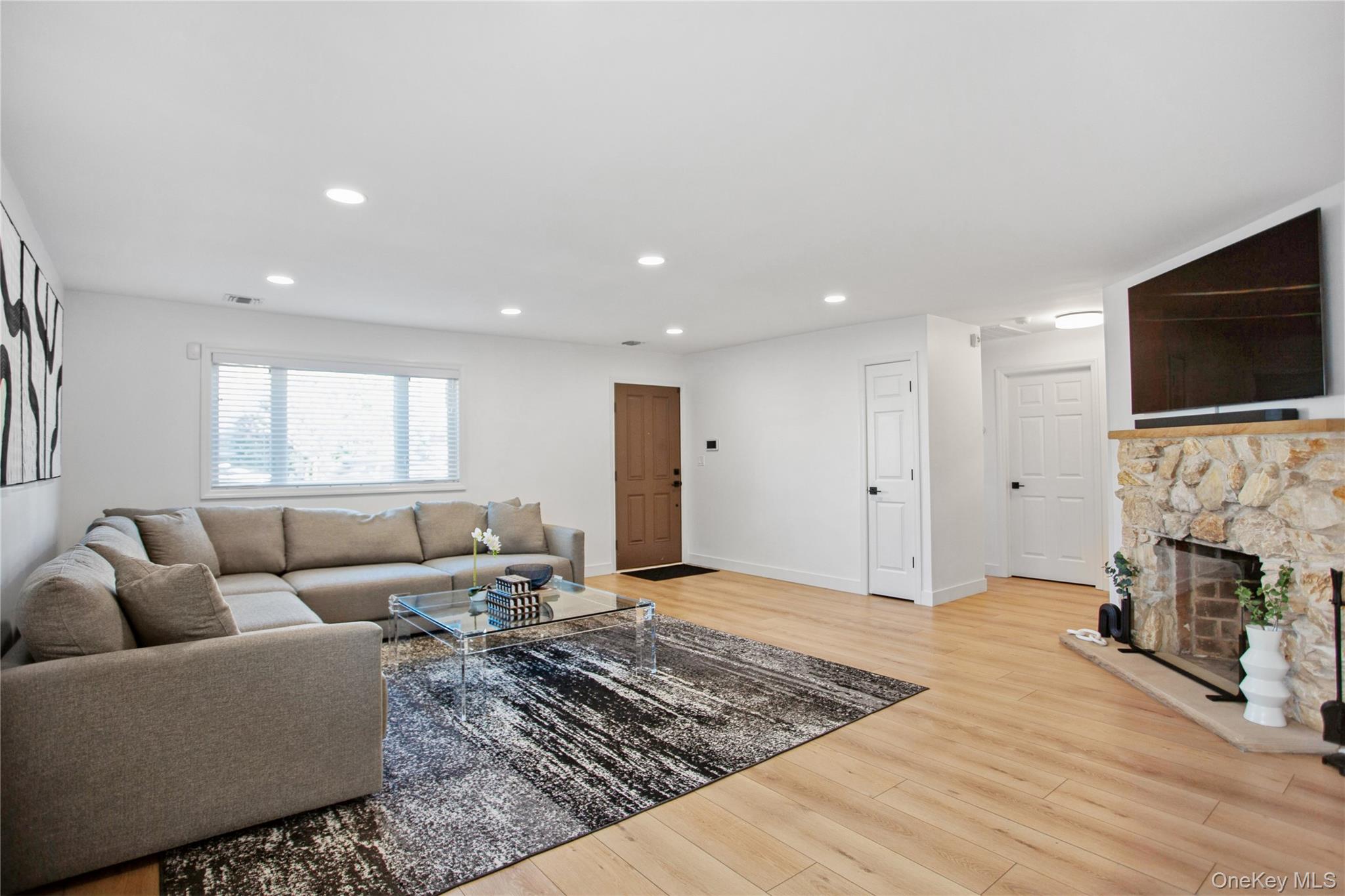 110 Hampton Way Merrick, NY 11566 - Photo 9 of 24 Living area with recessed lighting, light wood-style floors, and a fireplace