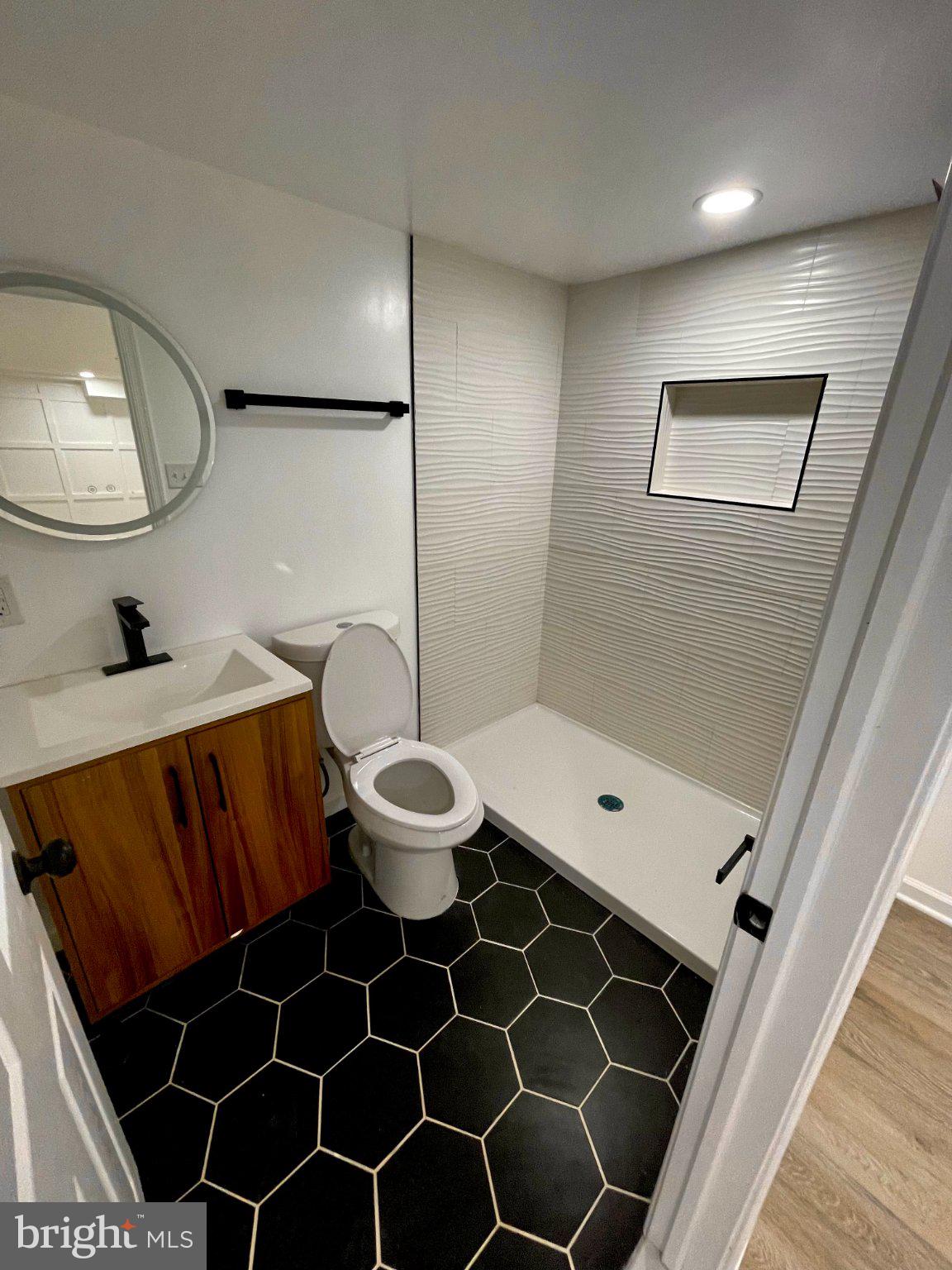3449 23rd Street Southeast Washington, DC 20020 - Photo 6 of 8 Sleek modern bathroom with stylish tiles.