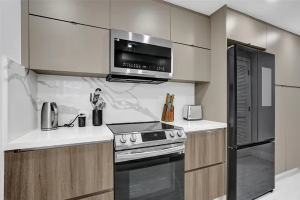 a kitchen with stainless steel appliances a sink a stove and a refrigerator