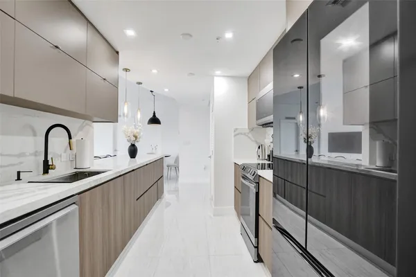 a kitchen with stainless steel appliances granite countertop a sink stove and cabinets
