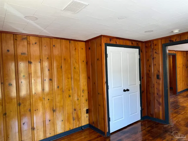 a view of a room with wooden floor