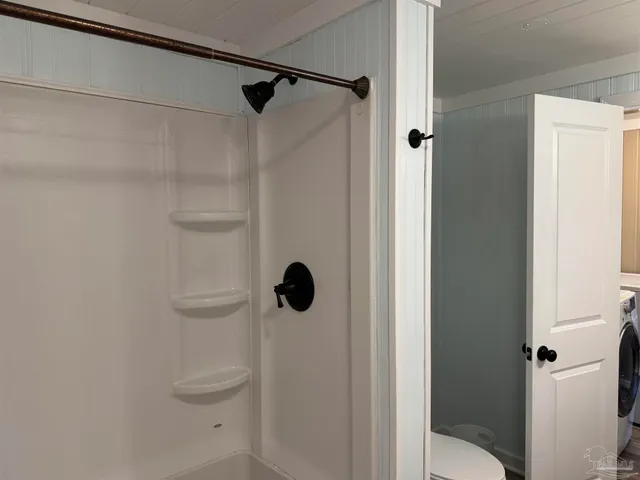 a bathroom with a shower and toilet