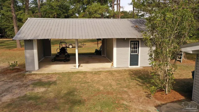 a view of a house with a yard covered in snow