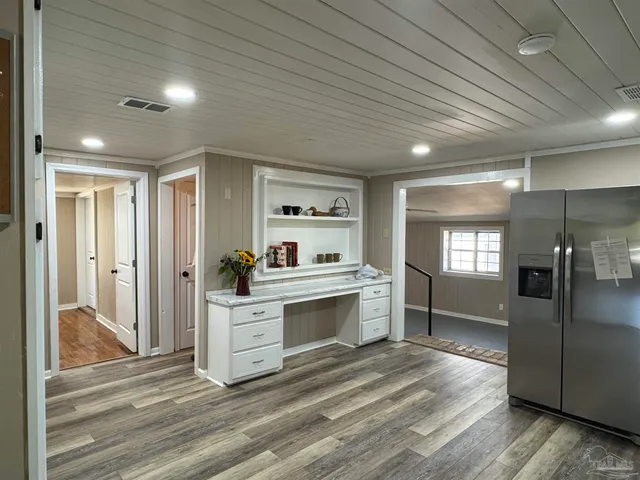 a large kitchen with kitchen island a counter space a sink appliances and cabinets