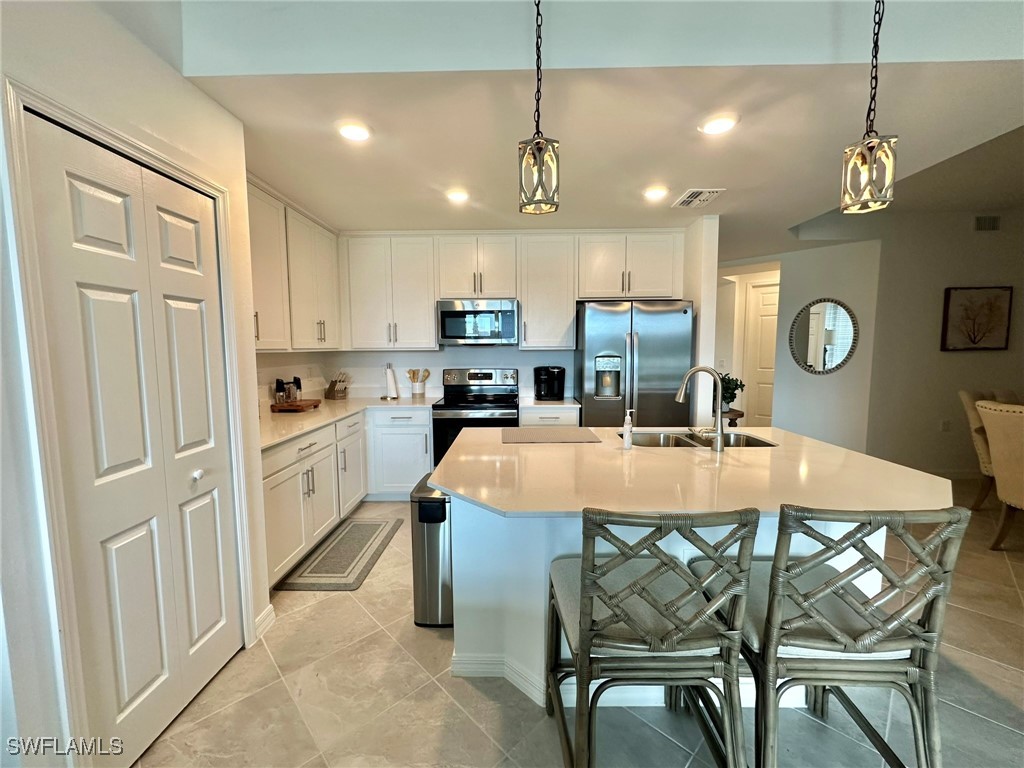 43989 Boardwalk Loop, Unit 2018 Coffeyville, KS 67337 - Photo 2 of 29 a large kitchen with a table and chairs