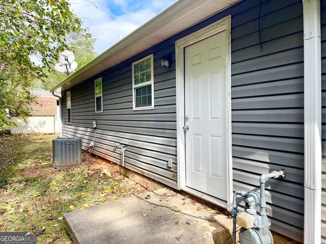 a backyard of a house with table and chairs