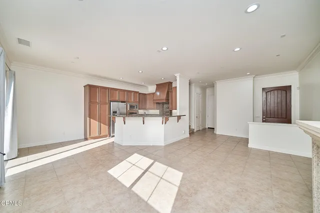 a view of kitchen with kitchen island sink and refrigerator