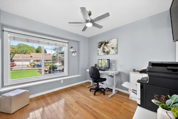 a bed sitting in a bedroom next to a window