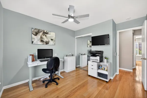 a spacious bedroom with a bed and a chandelier