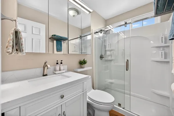 a view of a kitchen with stainless steel appliances granite countertop a refrigerator and a sink