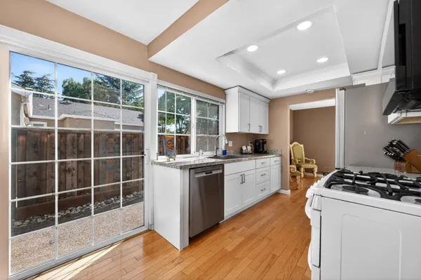 a kitchen with a stove a sink a refrigerator and cabinets