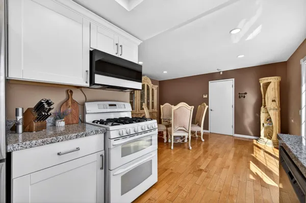 a view of a balcony with potted plants and wooden fence