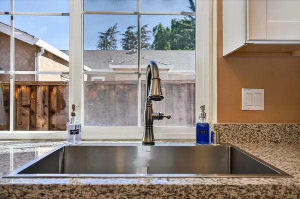 a patio with a table and chairs under an umbrella