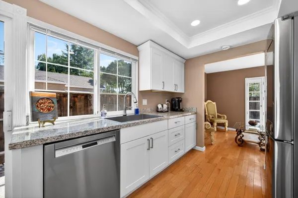 a view of a patio with table and chairs under an umbrella