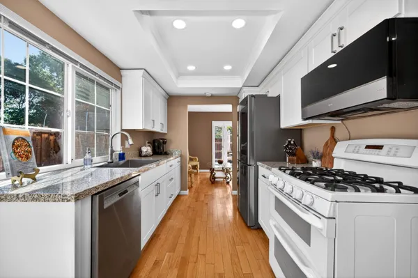 a view of a patio with a table and chairs under an umbrella