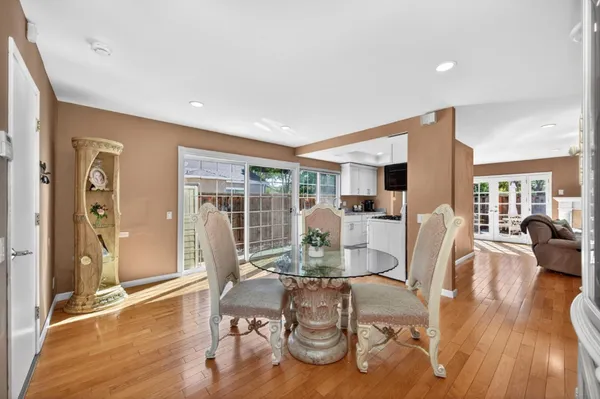 a view of a backyard with plants and wooden fence