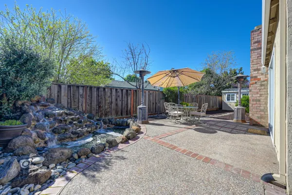 a view of a backyard with table and chairs