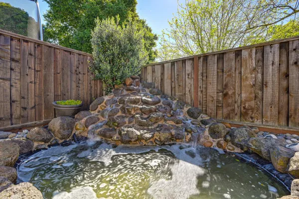 a view of a house with backyard and sitting area