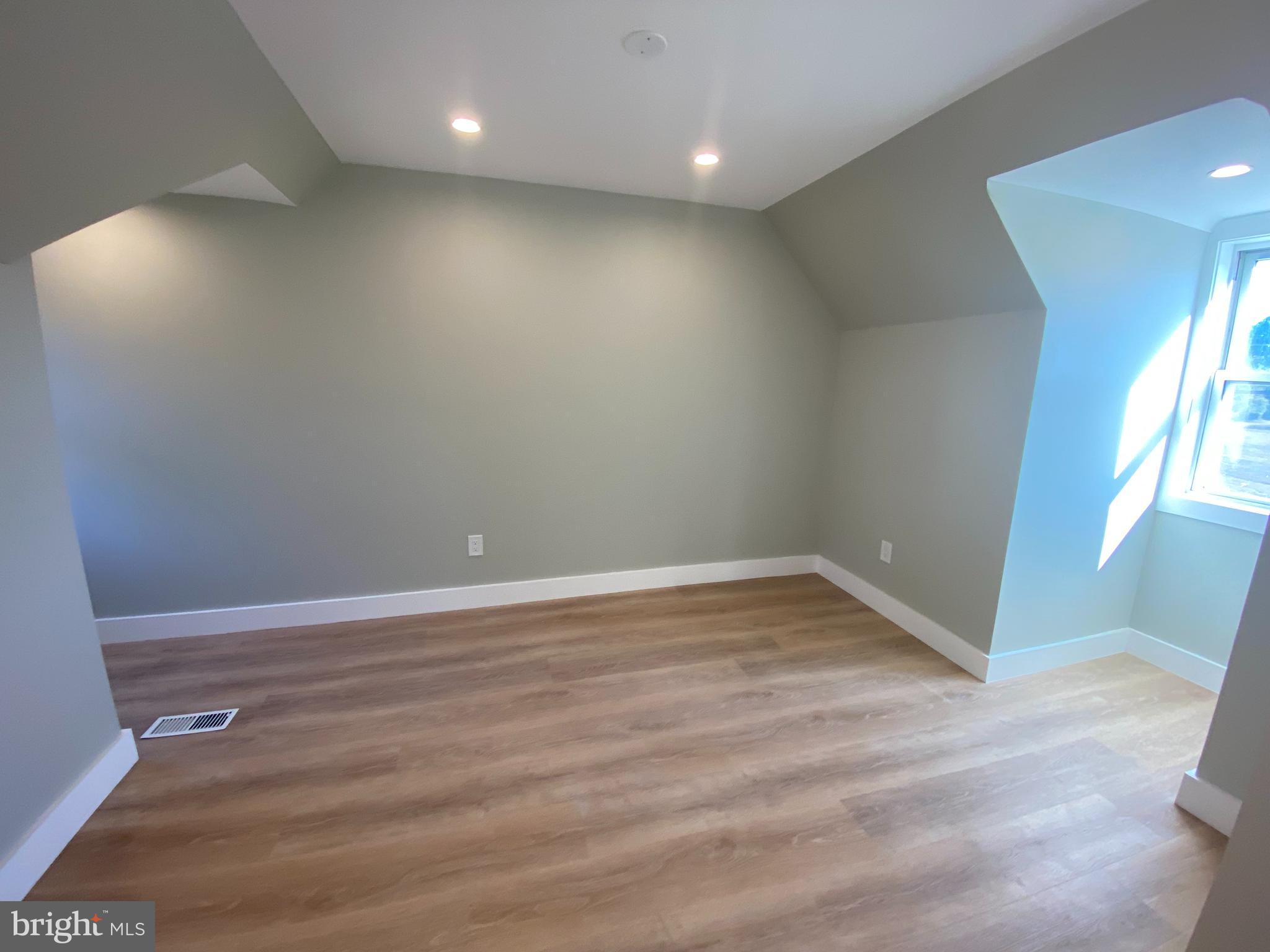 1104 Highway 77 Bridgeton, NJ 08302 - Photo 16 of 21 an empty room with wooden floor and windows