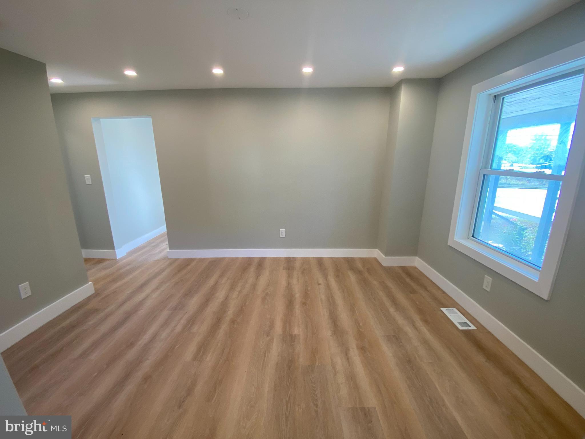 1104 Highway 77 Bridgeton, NJ 08302 - Photo 3 of 21 an empty room with wooden floor and windows