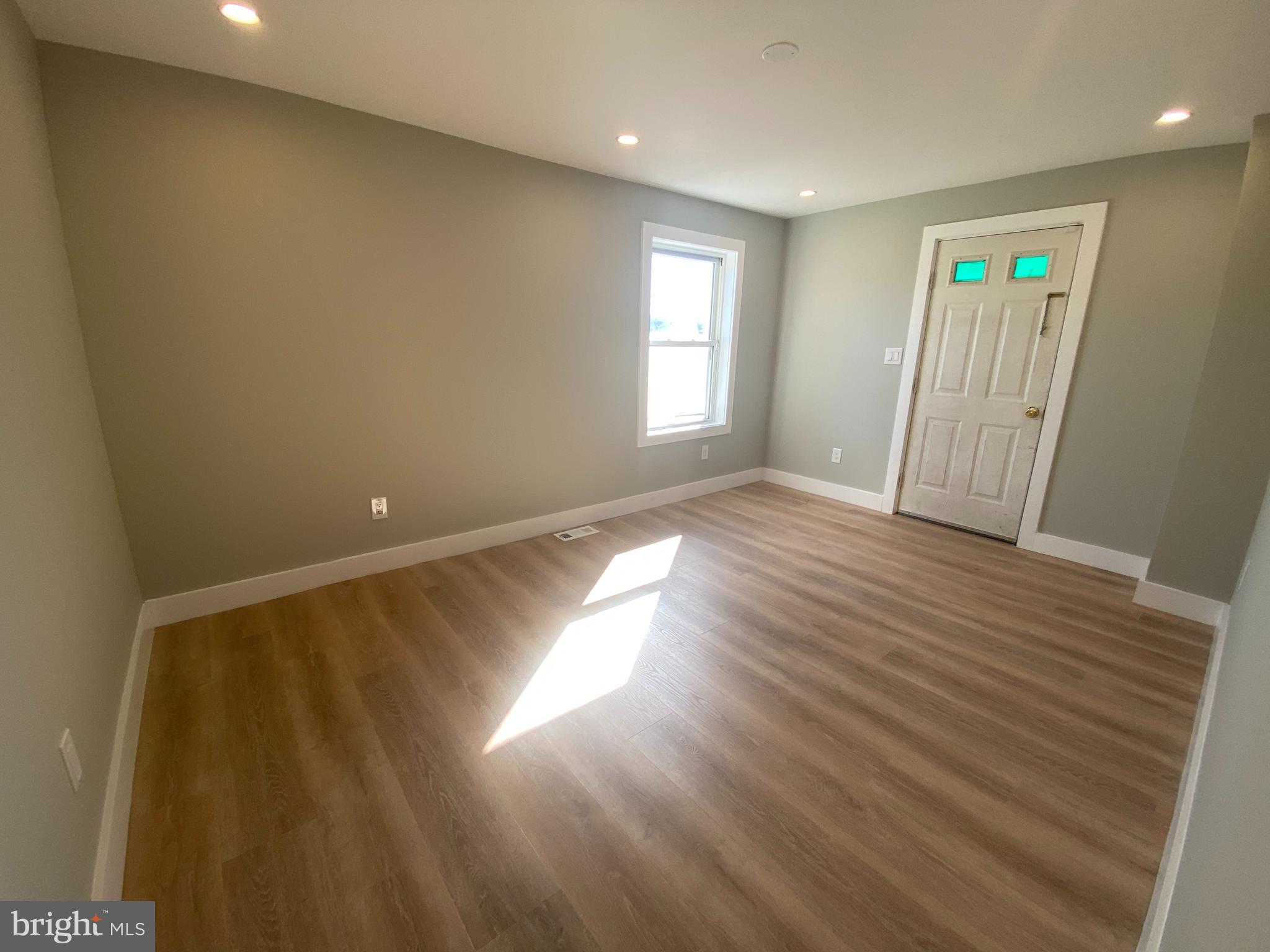 1104 Highway 77 Bridgeton, NJ 08302 - Photo 4 of 21 wooden floor in an empty room with a window