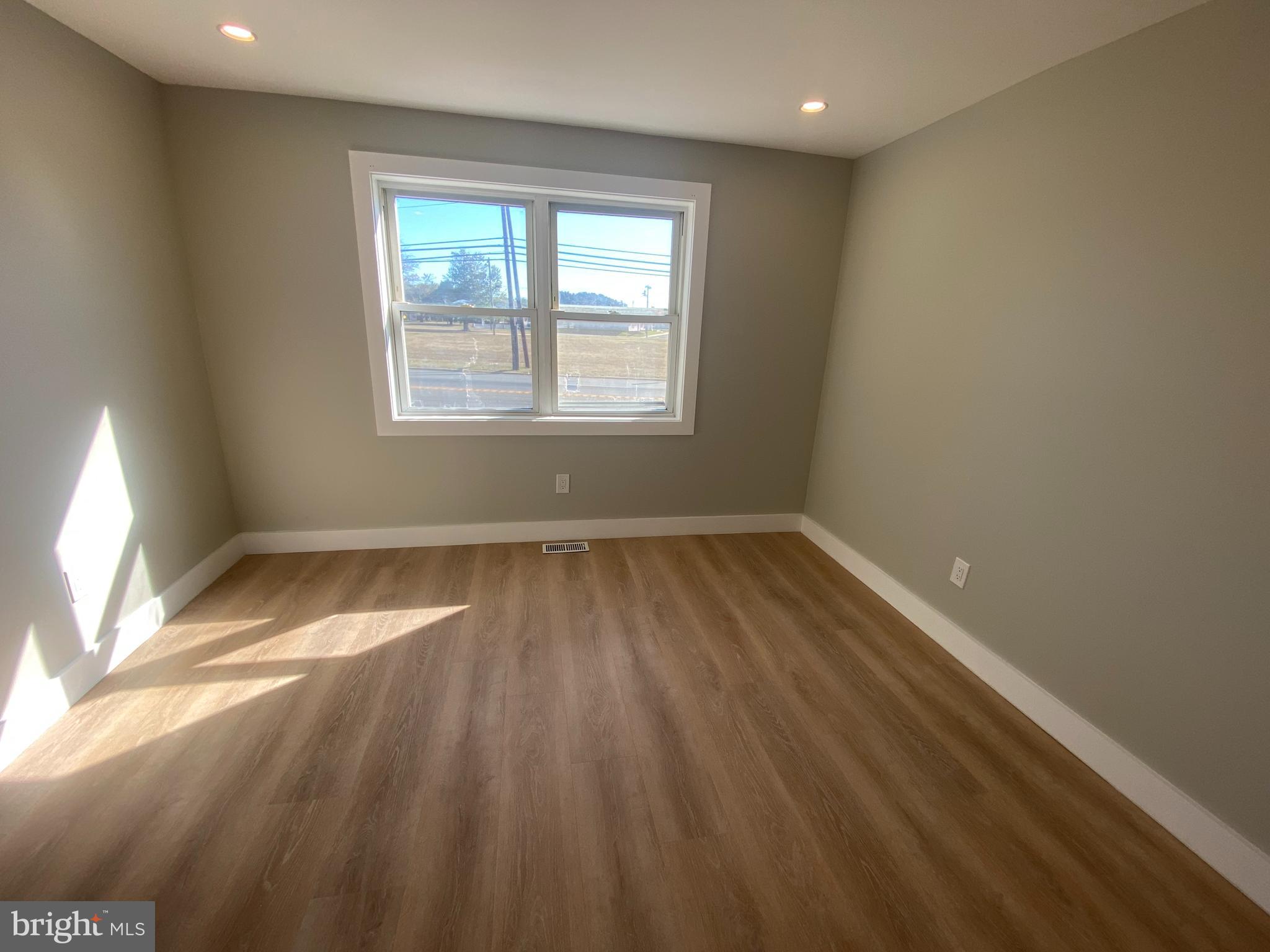 1104 Highway 77 Bridgeton, NJ 08302 - Photo 5 of 21 an empty room with wooden floor and windows