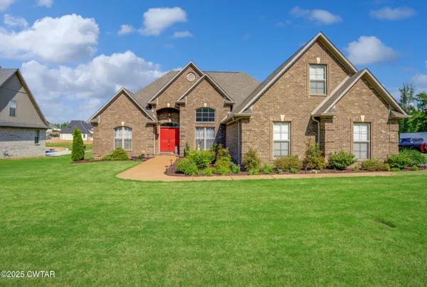 a front view of house with yard and green space