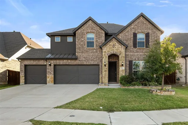 a front view of a house with a yard and garage