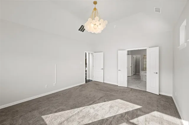 a view of a hallway with a chandelier fan and wooden floor