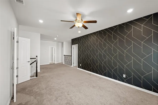 a view of a livingroom with a ceiling fan and closet area