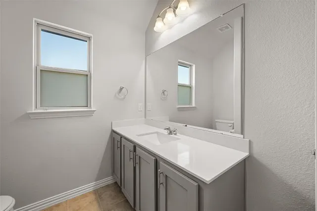 a bathroom with a sink vanity and a mirror