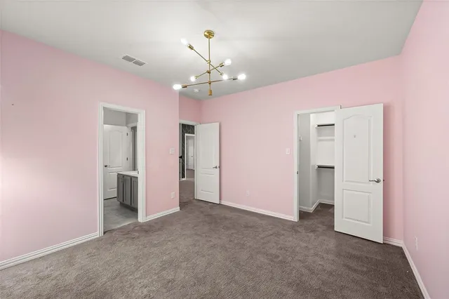 wooden floor in an empty room with a bathroom