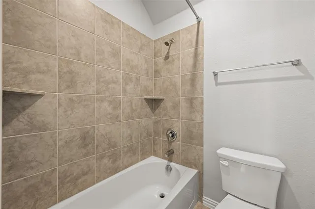 a bathroom with a bathtub and a toilet