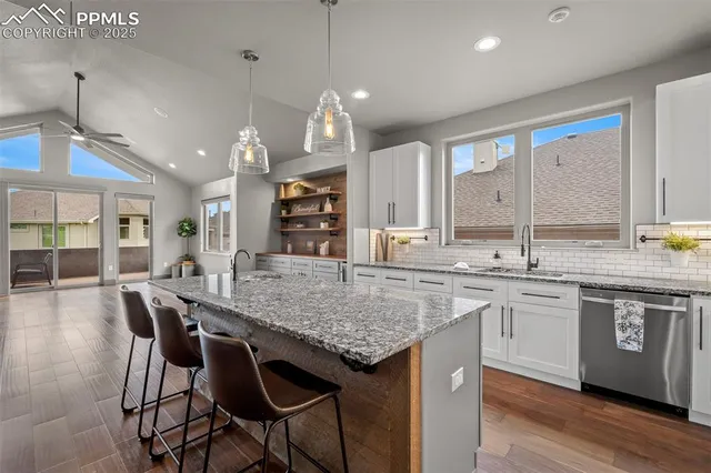 a kitchen with center island table and chairs