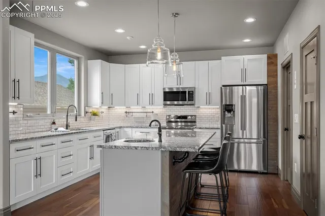 a kitchen with refrigerator cabinets and a sink