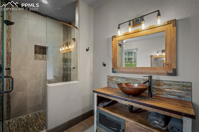 a bathroom with a sink a mirror and shower
