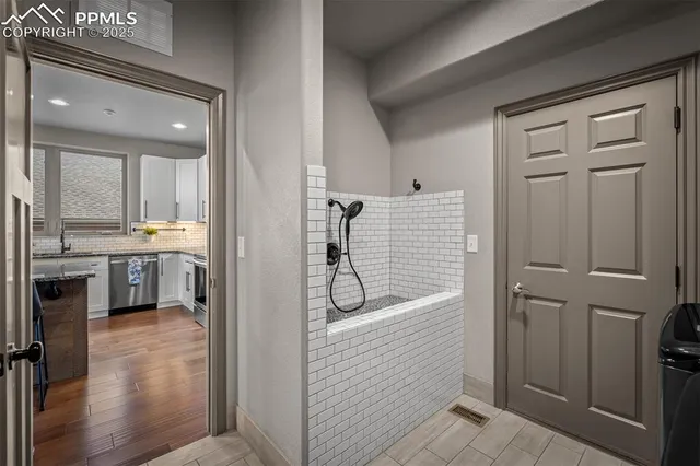 a bathroom with a tub shower vanity and a sink