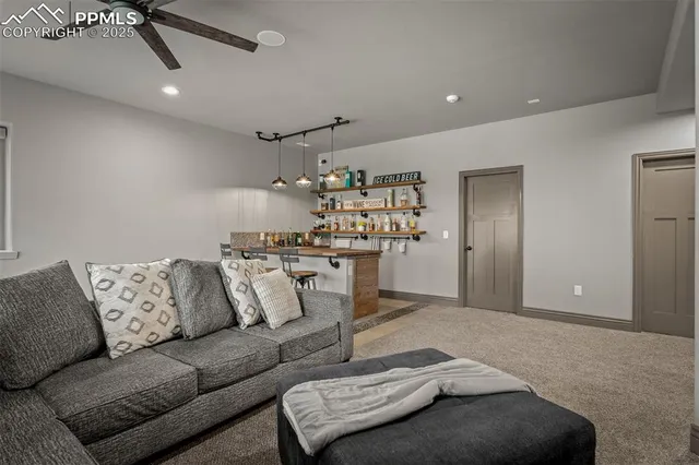 a living room with furniture and kitchen view