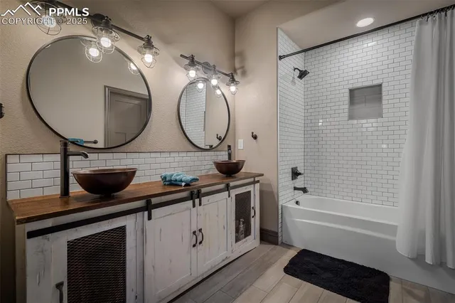 a bathroom with a double vanity sink and a mirror