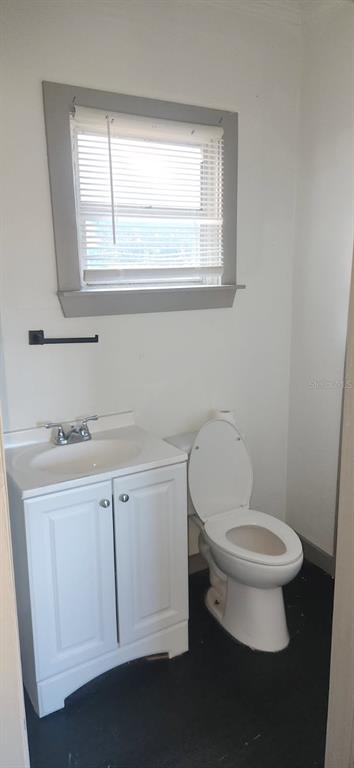 1330 Pine Street Altamonte Springs, FL 32701 - Photo 12 of 13 a bathroom with a toilet a sink a window and mirror
