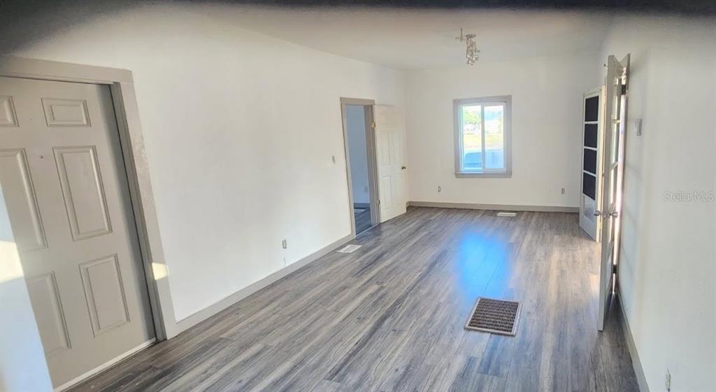 1330 Pine Street Altamonte Springs, FL 32701 - Photo 2 of 13 an empty room with wooden floor and windows