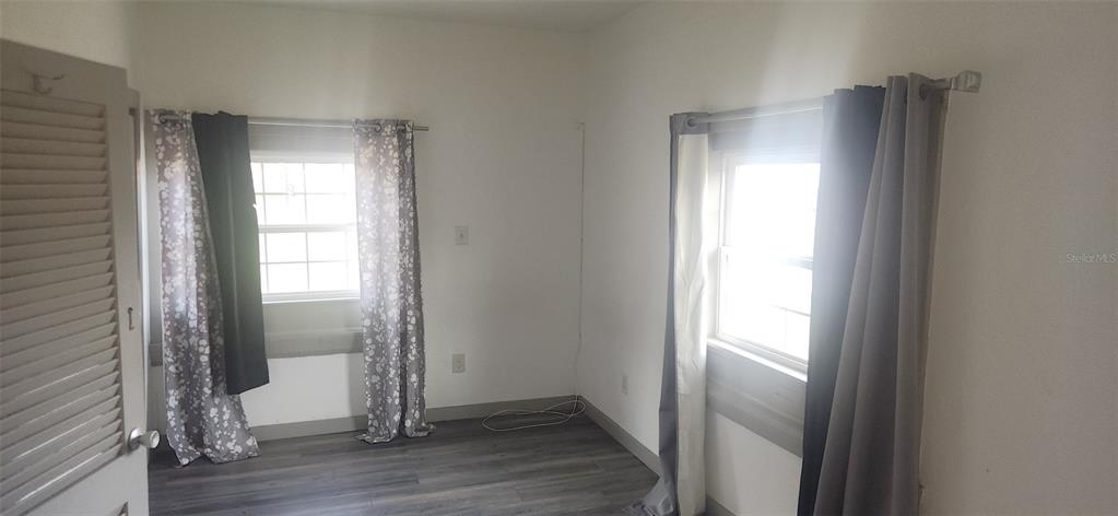 1330 Pine Street Altamonte Springs, FL 32701 - Photo 4 of 10 a view of an empty room with wooden floor and a window