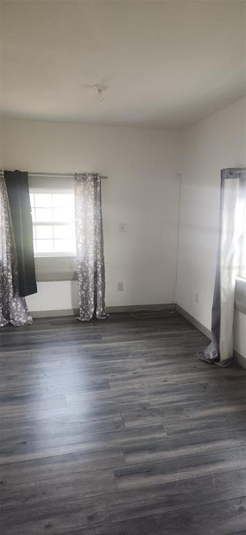 1330 Pine Street Altamonte Springs, FL 32701 - Photo 5 of 10 an empty room with wooden floor and windows