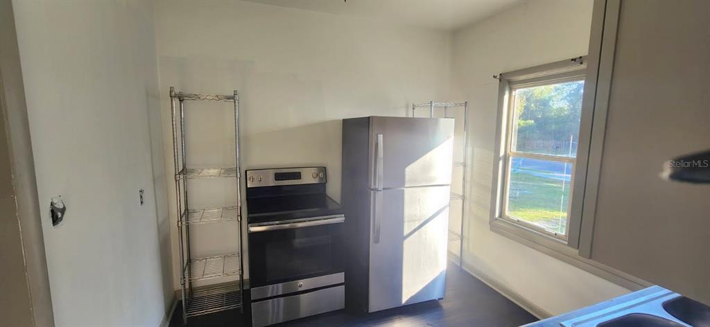 1330 Pine Street Altamonte Springs, FL 32701 - Photo 6 of 13 a metallic refrigerator freezer and a refrigerator in a kitchen