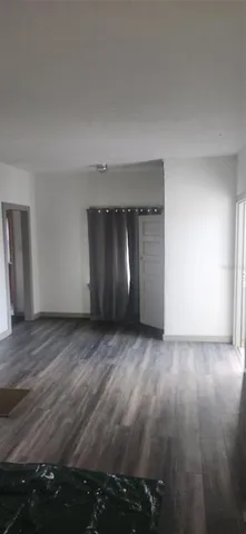 a view of an empty room and wooden floor